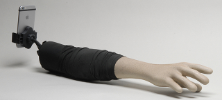Illustration for article titled A Fake Arm Selfie Stick Only Makes You Look Less Sad in Photographs